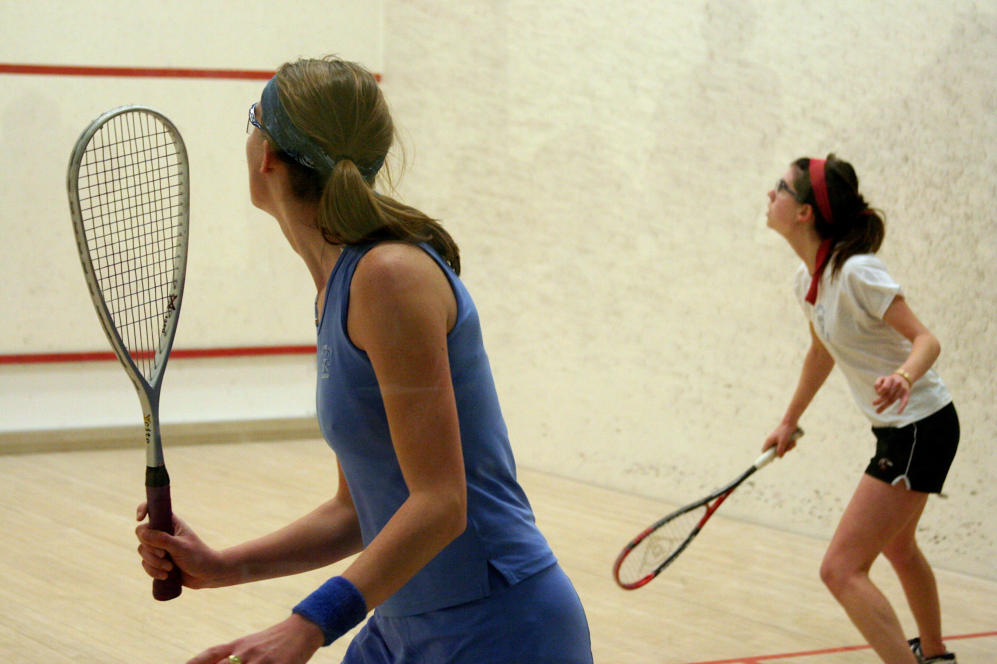 Two squash players contesting a rally